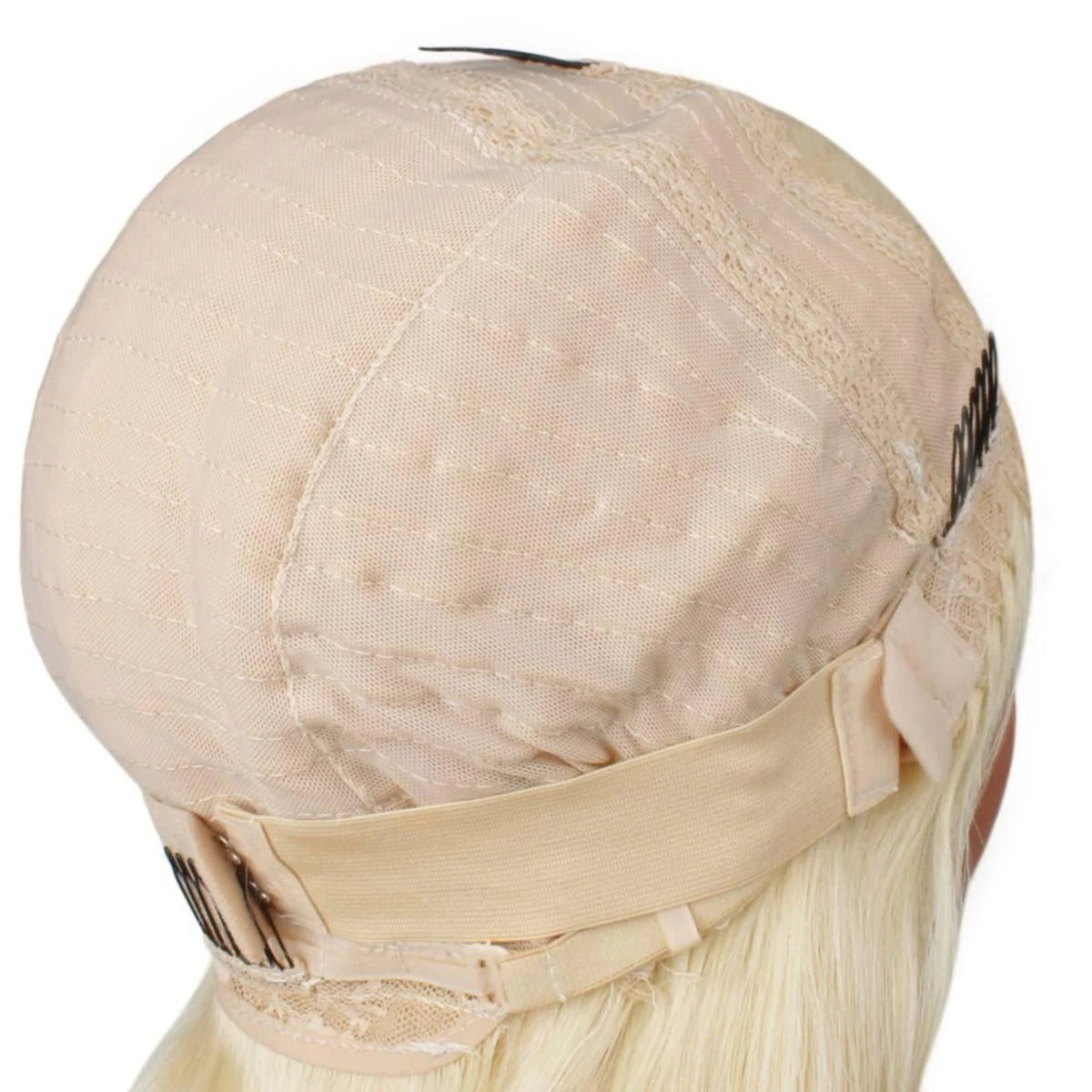 Interior of the cap on a platinum blonde reverse ombre body wave human hair wig seen from behind showing the mesh dome, elastic band and combs