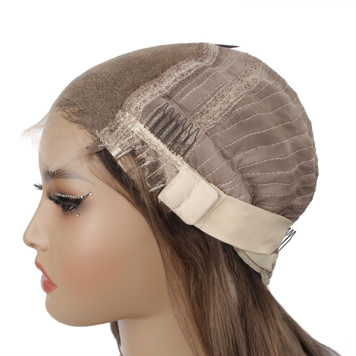 Cap of a chocolate brown to platinum blonde straight bob human hair wig folded back on a mannequin showing the lace, a comb and the adjustable strap
