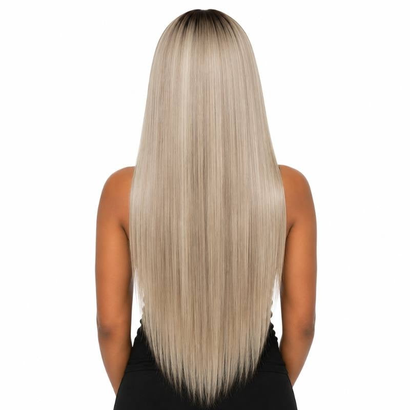 Back view of a model wearing a chocolate brown rooted platinum blonde straight human hair wig showing the straight lengths and darker roots