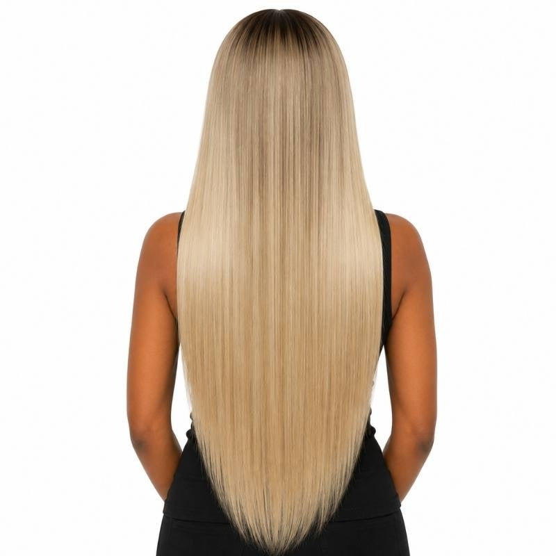 Back view of a model wearing a chocolate brown rooted platinum blonde straight human hair wig showing the straight lengths down the back