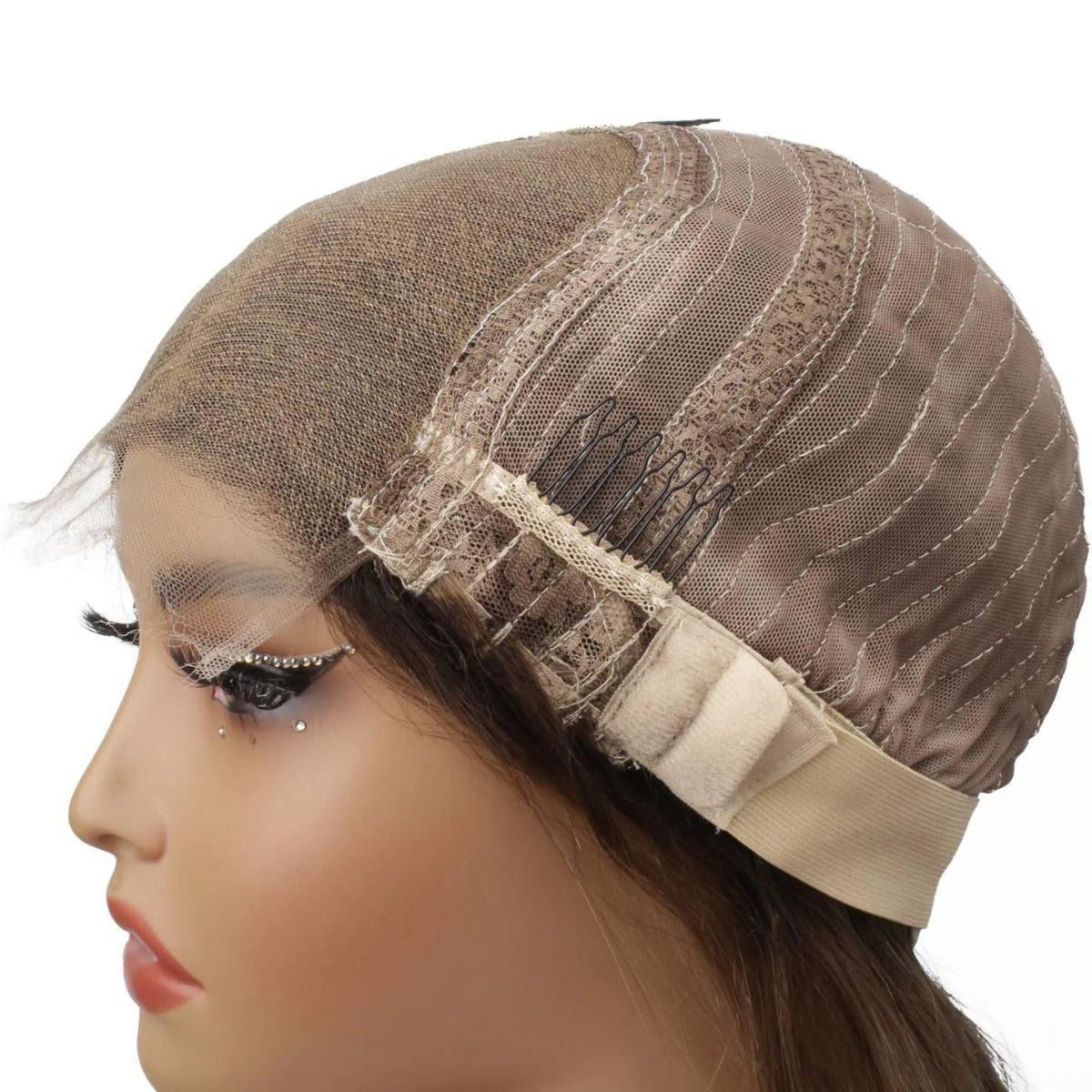 Cap of a chocolate brown to platinum blonde straight human hair wig folded back on a mannequin showing the lace panel, a comb and the adjustable strap