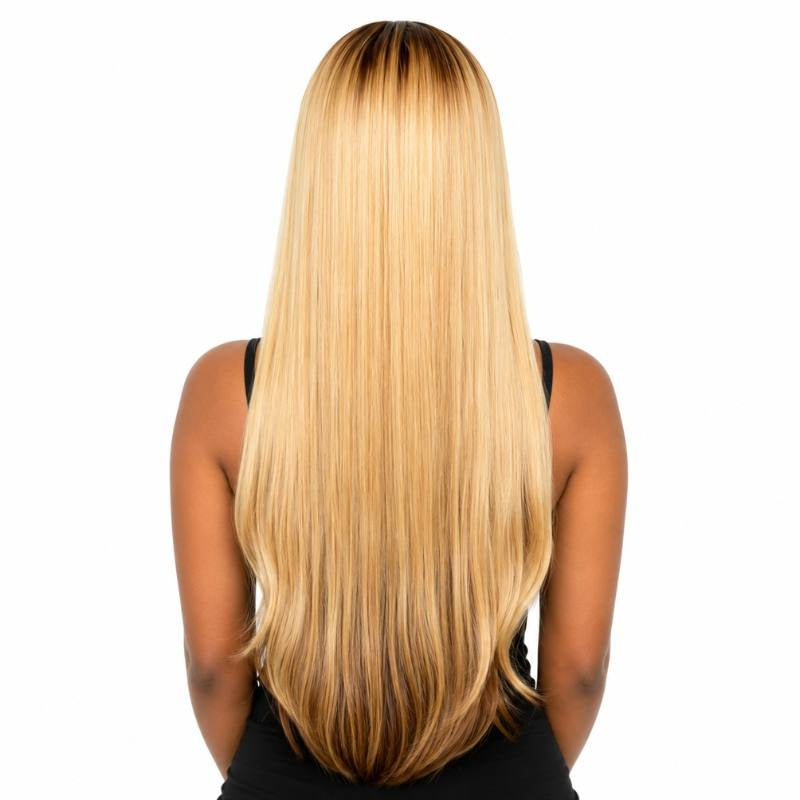 Back view of a model wearing a toffee and blonde balayage straight human hair wig showing blonde lengths and darker roots