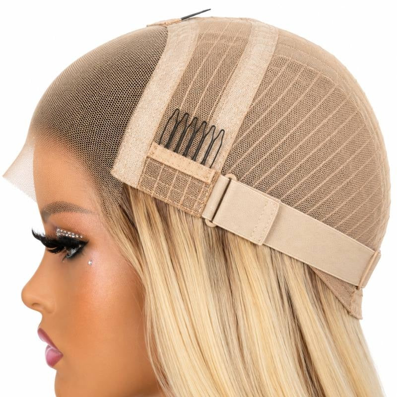 Cap of a toffee and blonde balayage straight human hair wig folded back on a mannequin showing the lace, a comb and the adjustable strap