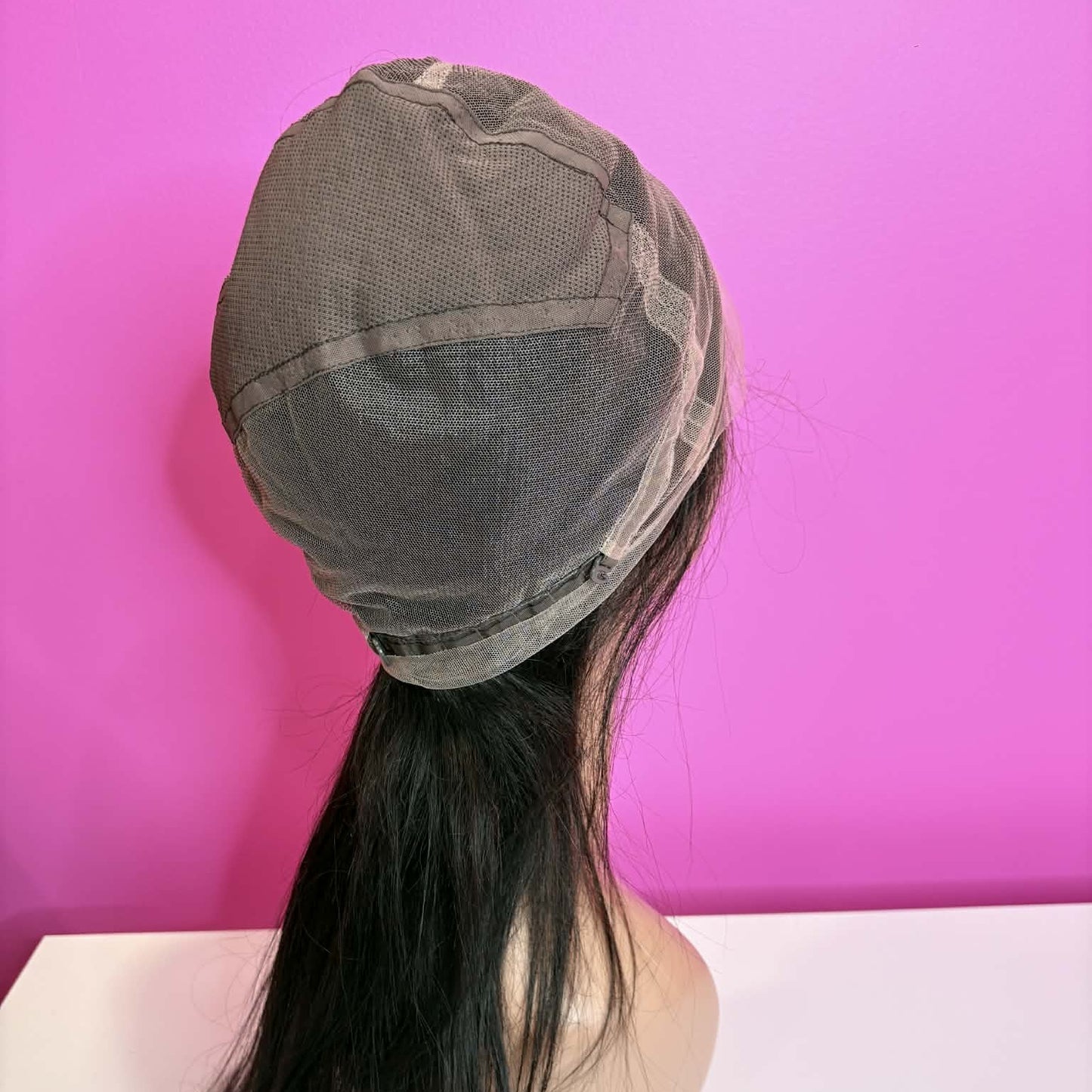 Interior back cap view of 20 inch straight lace front human hair wig showing adjustable straps and construction