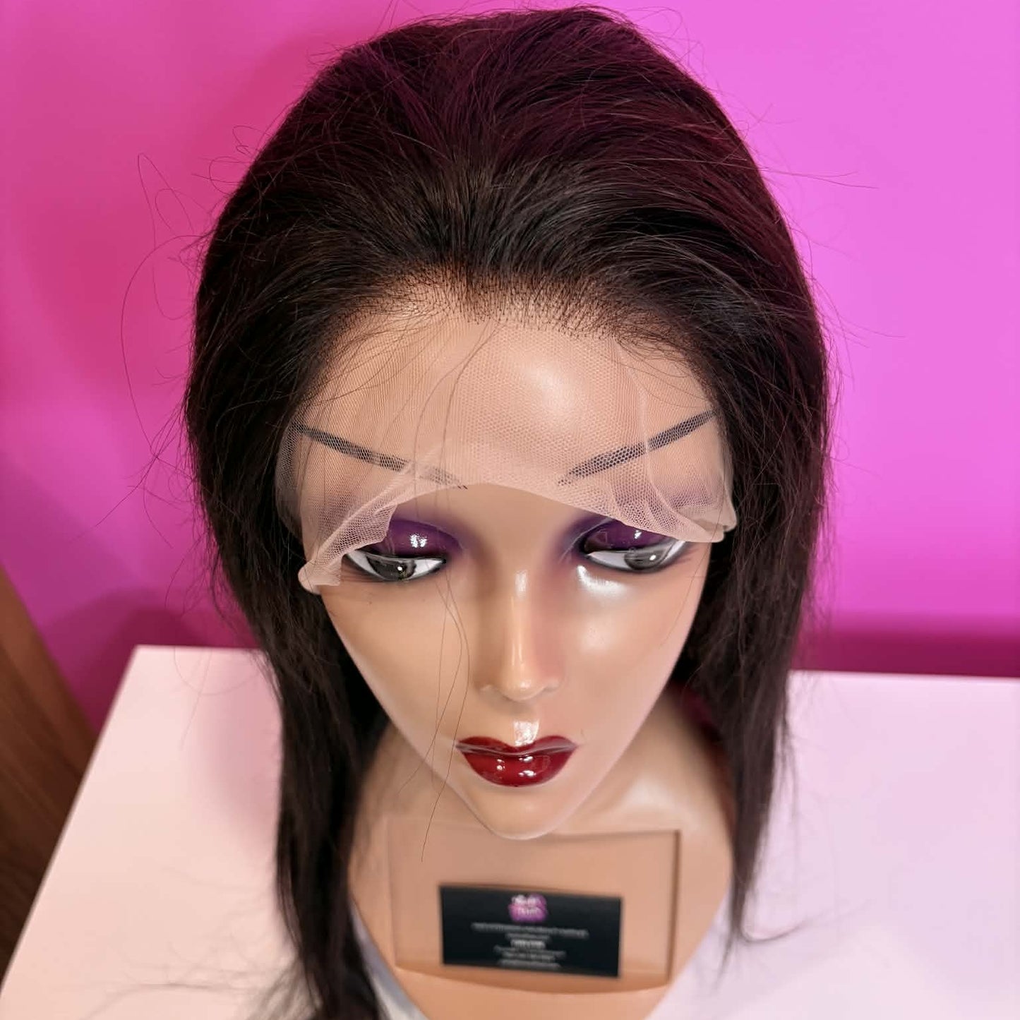 Above angle view of 20 inch straight lace front human hair wig on mannequin showing HD lace hairline and parting