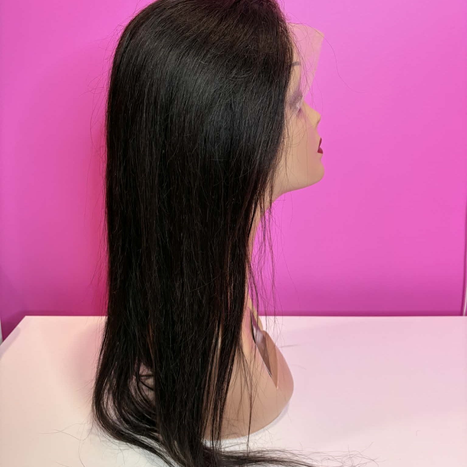 Left side profile of 20 inch straight 13x4 HD lace front human hair wig on mannequin showing length and straight texture