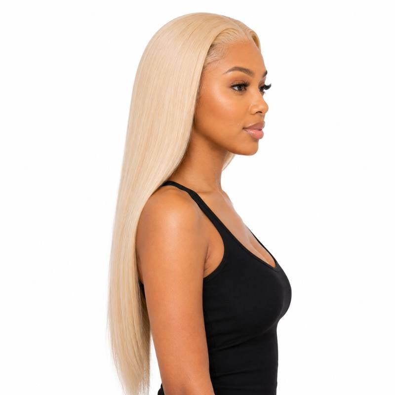 Side profile of a model wearing a blonde straight human hair wig showing the smooth straight lengths past the chest