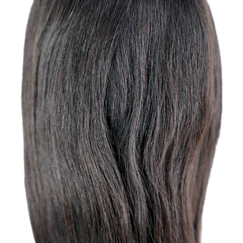 Close-up of the ends on a natural black straight human hair wig showing the straight strands and the cut line