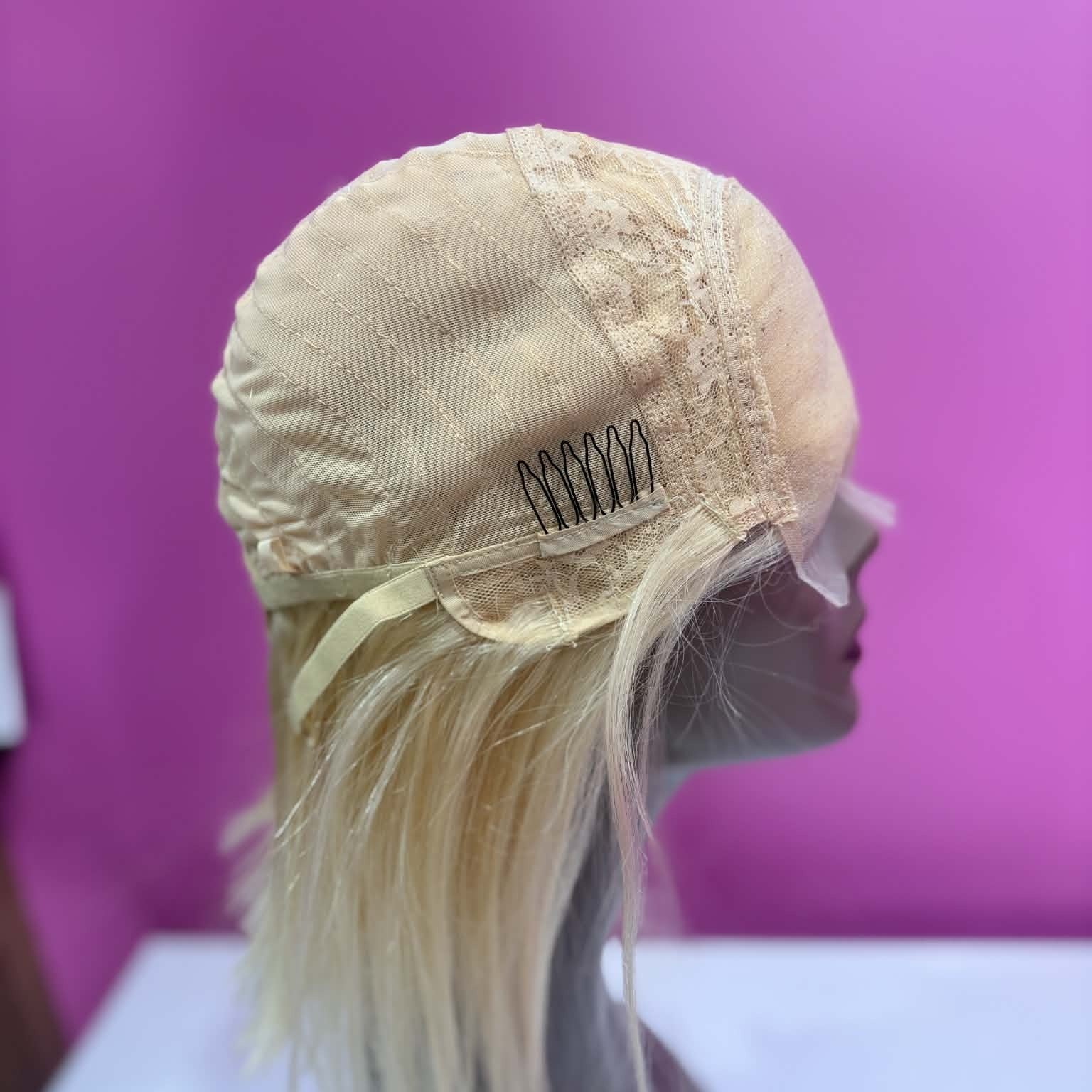 Interior left cap view of 10 inch blonde bob human hair wig showing weft rows and machine-made construction