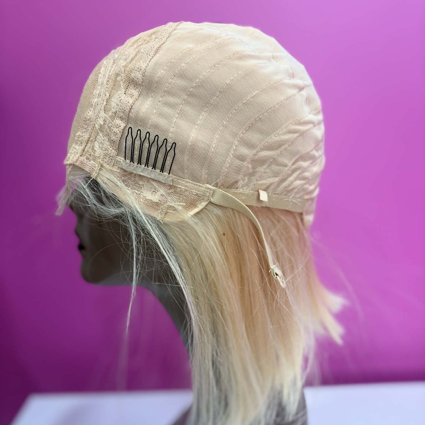 Interior right cap view of 10 inch blonde bob human hair wig showing weft construction and cap edge