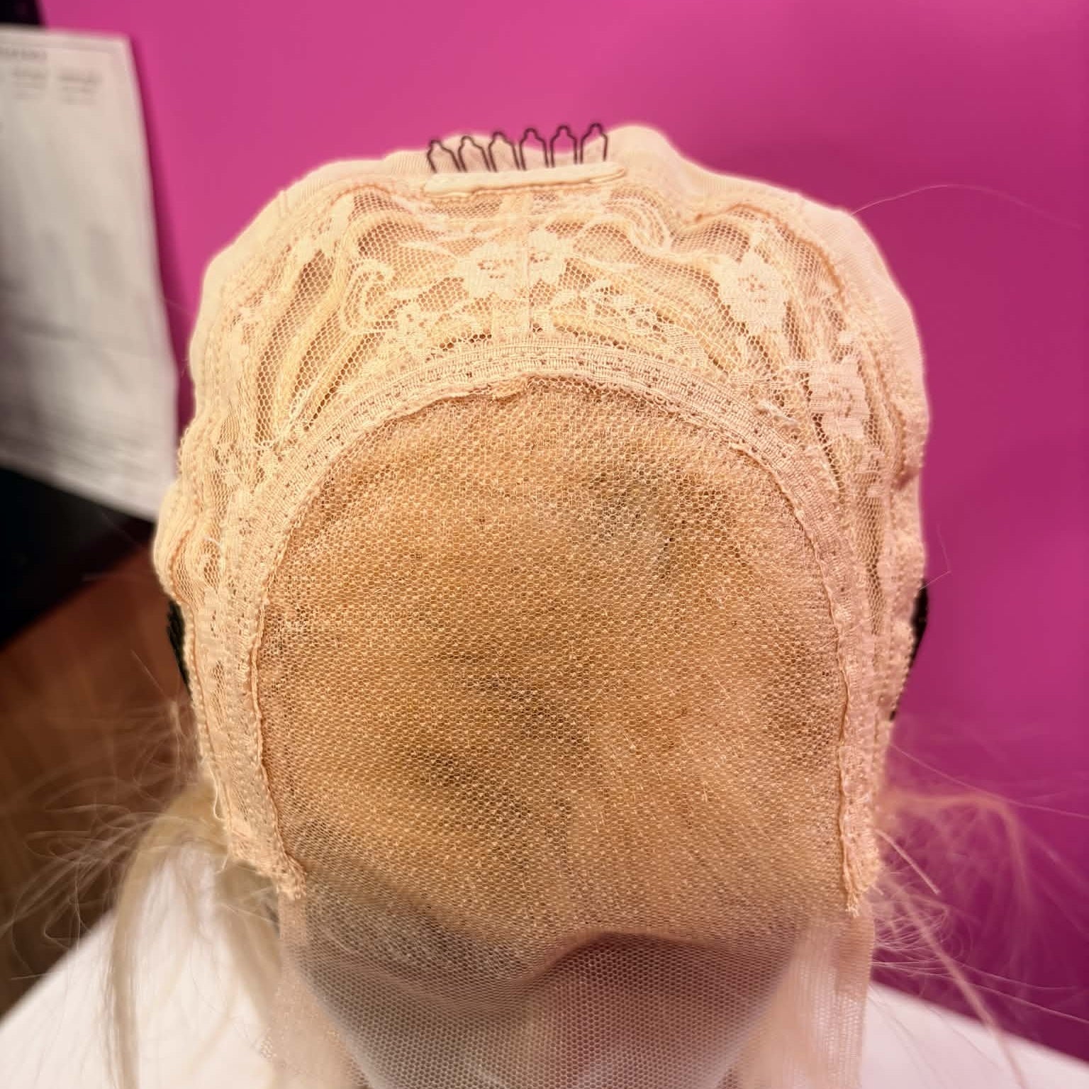 Interior top cap view of 10 inch blonde bob human hair wig showing 4x4 transparent lace closure area