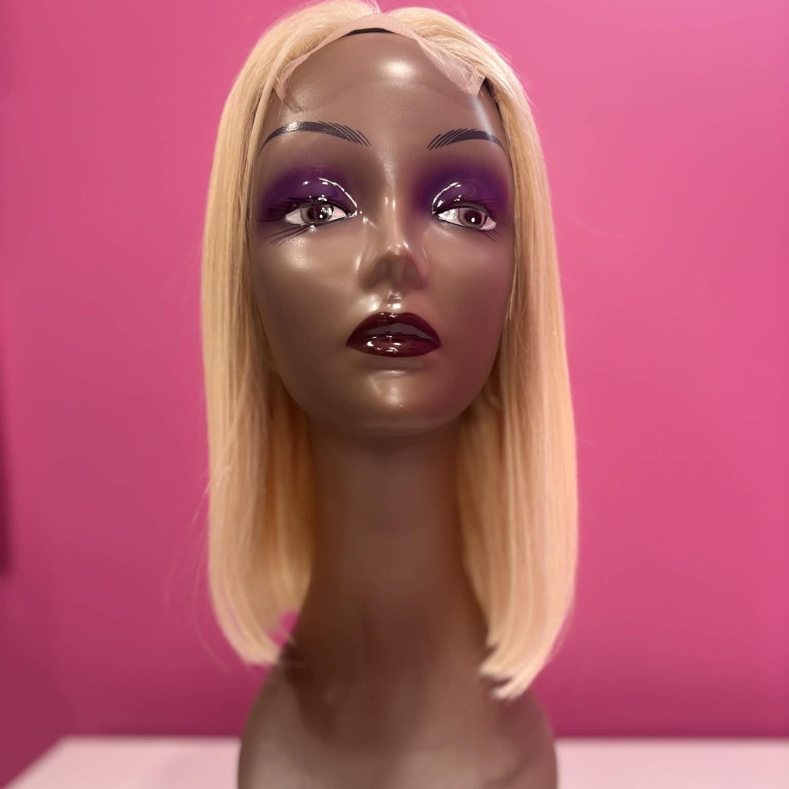 Front view of 10 inch blonde 613 straight bob lace human hair wig on mannequin showing lace closure parting and chin-length cut