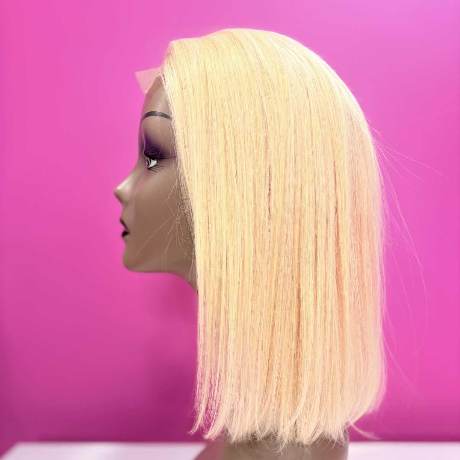 Left side profile of 10 inch blonde 613 straight bob lace human hair wig on mannequin showing blunt cut at jaw line