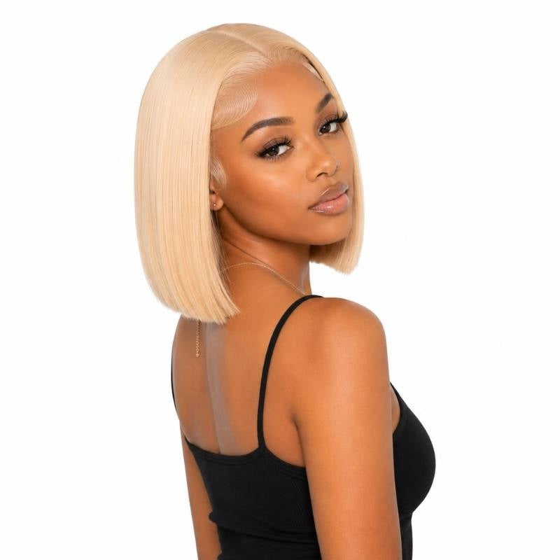 Model turned away wearing a blonde straight bob human hair wig showing a middle part and the blunt cut at the shoulder