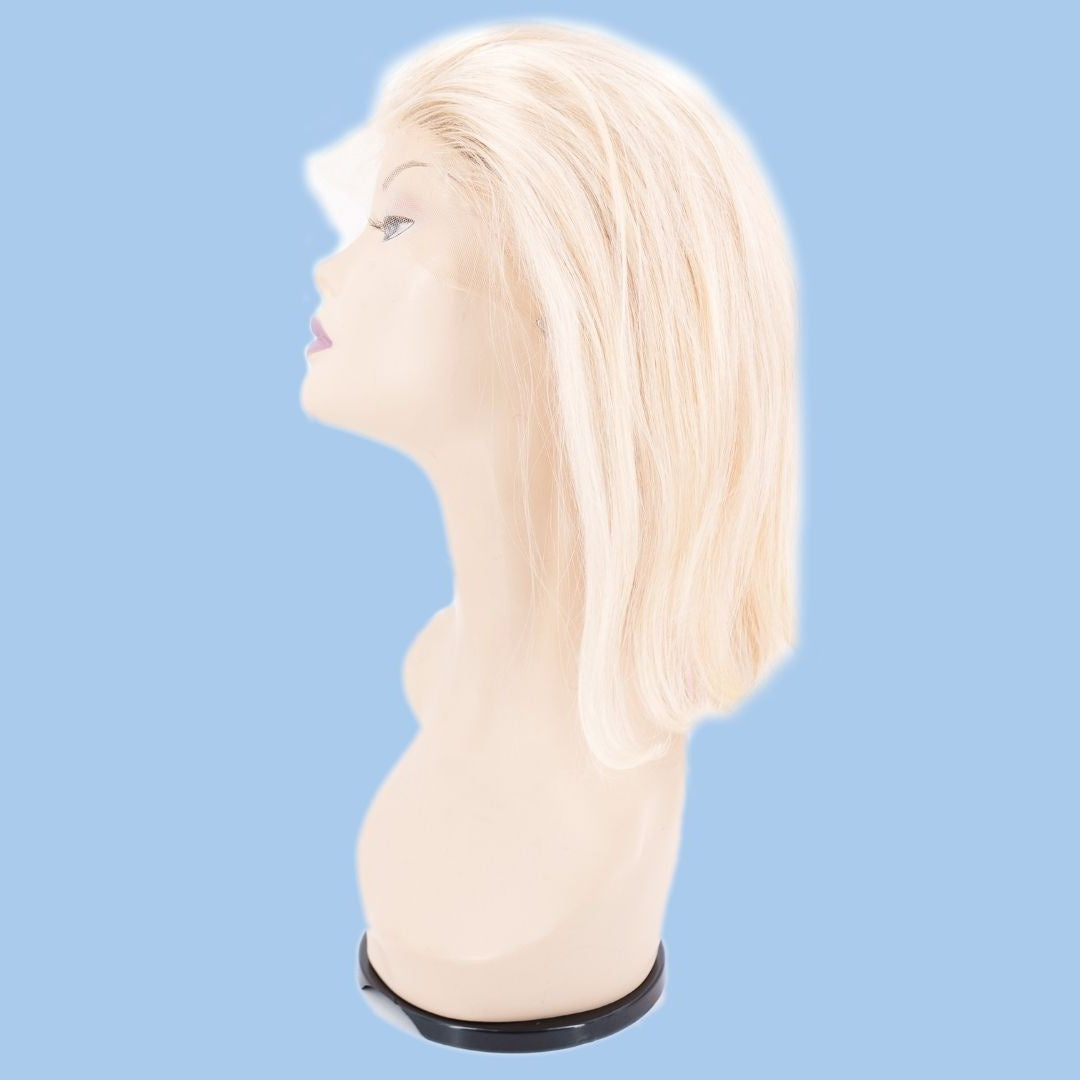 Blonde straight bob human hair wig on a mannequin head from the side against a blue background with the lace front laid over the face
