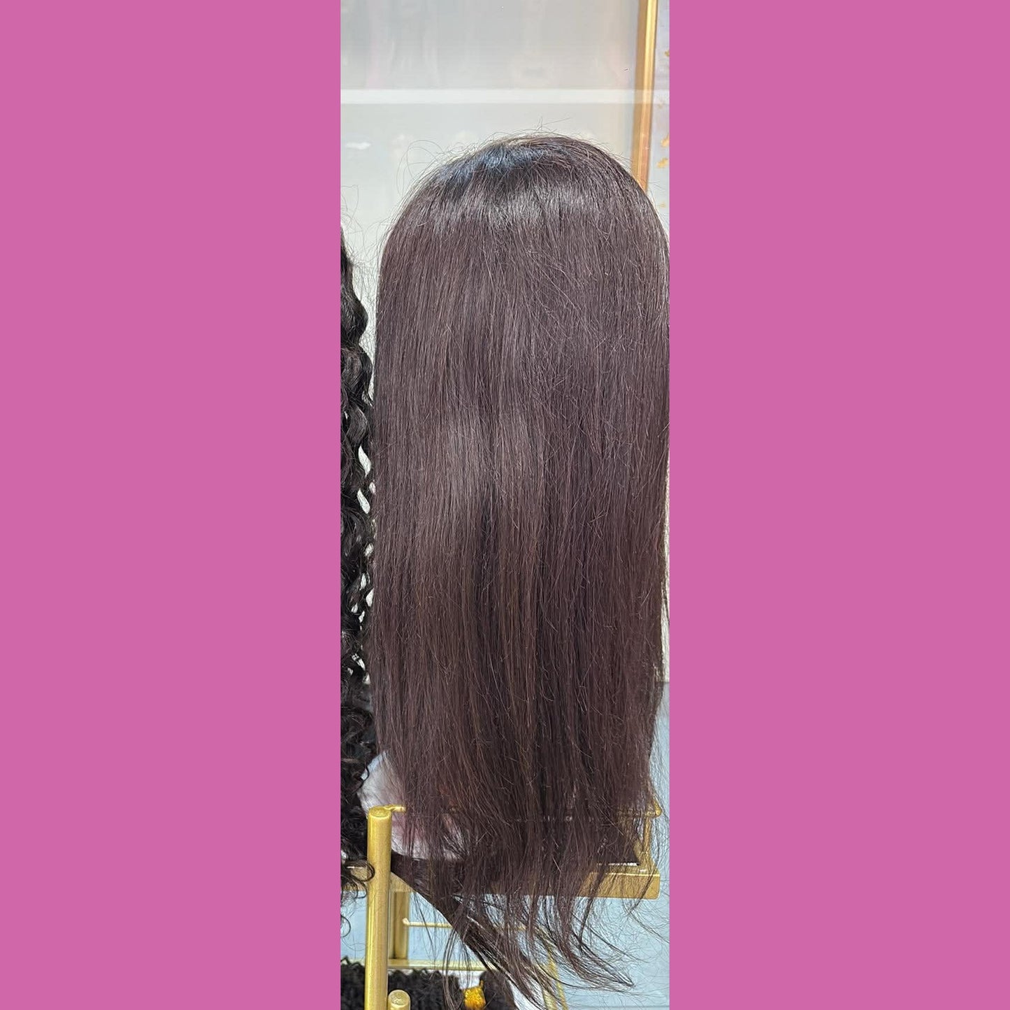 Back view of 18 inch straight full transparent lace human hair wig in natural black 1B on mannequin in showroom showing straight texture and full length
