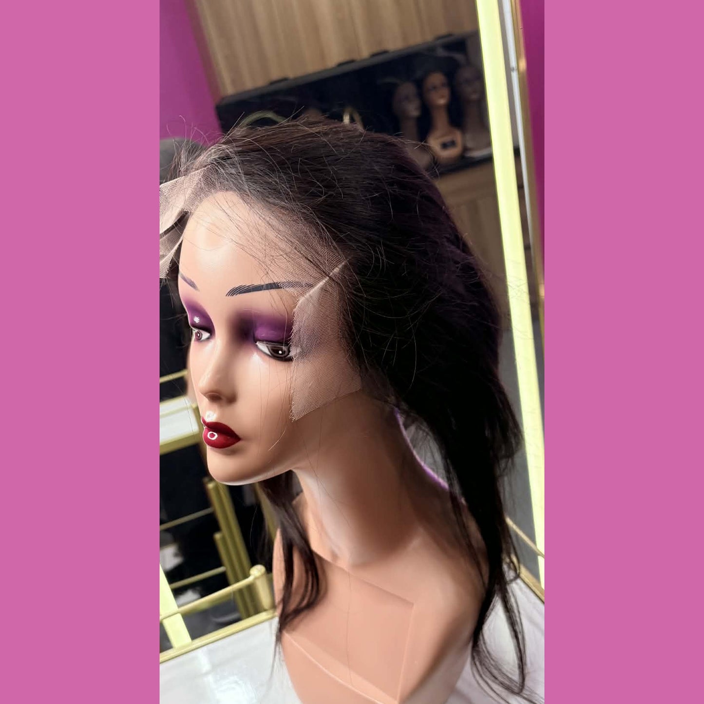 Side view of 18 inch straight full transparent lace human hair wig on mannequin in showroom showing lace cap and sleek straight hair