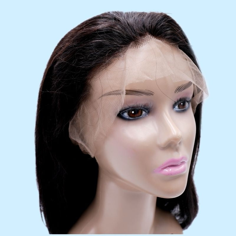 Natural black straight human hair wig on a mannequin head with the uncut lace hairline draped over the forehead against a blue background
