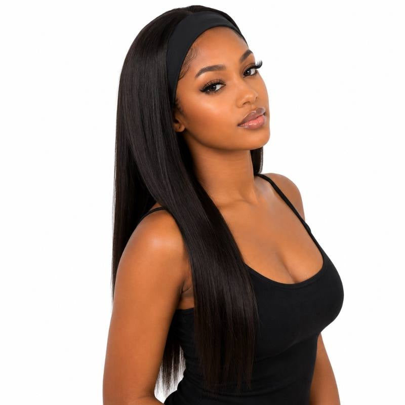 Model at a slight angle wearing a long natural black straight human hair wig held by a black headband against a white background