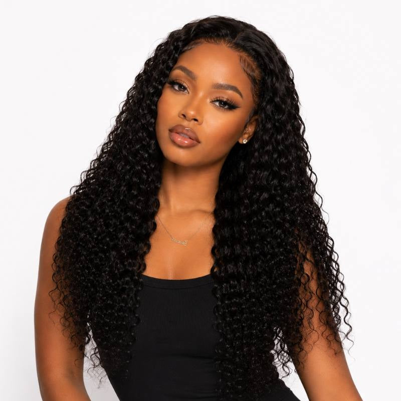 Model wearing a long natural black water wave human hair wig with defined curls falling past the shoulders on a white background