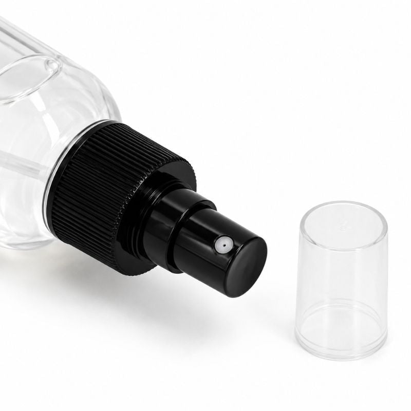 Close-up of the black spray pump and clear over cap on the lace paste remover bottle used on hair extensions and wig adhesive