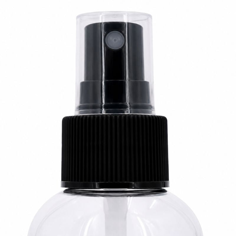 Macro view of the ribbed black collar and clear over cap on the lace paste remover spray bottle for hair extensions and wig adhesive