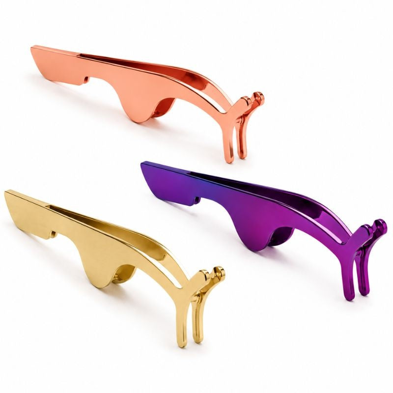 Three metal lash applicator tools in rose gold, gold and purple finishes arranged on white, a tool stocked alongside hair extensions