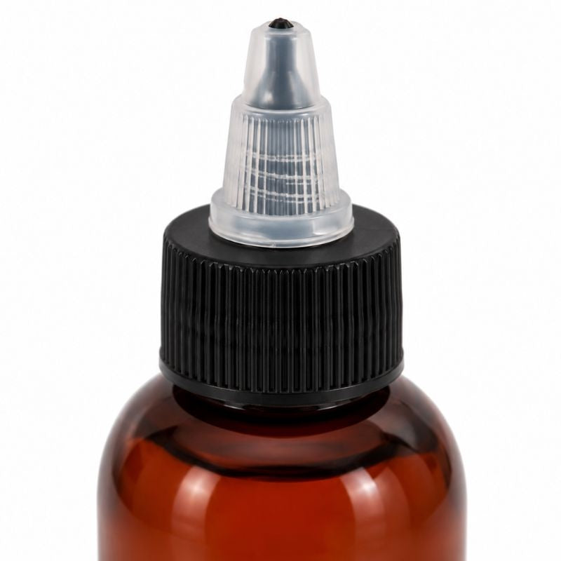 Macro view of the black ribbed collar and clear twist open nozzle on the amber scalp serum bottle used with hair extensions and wigs