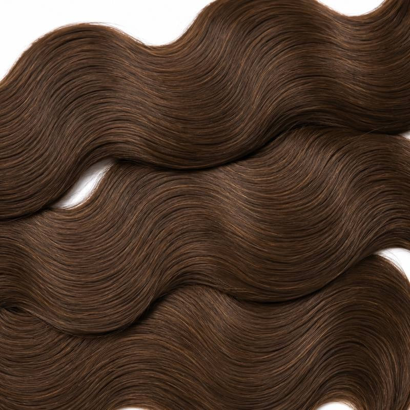 Macro crop of the S shaped wave pattern in medium brown 4 body wave sew-in hair extensions filling the frame on white