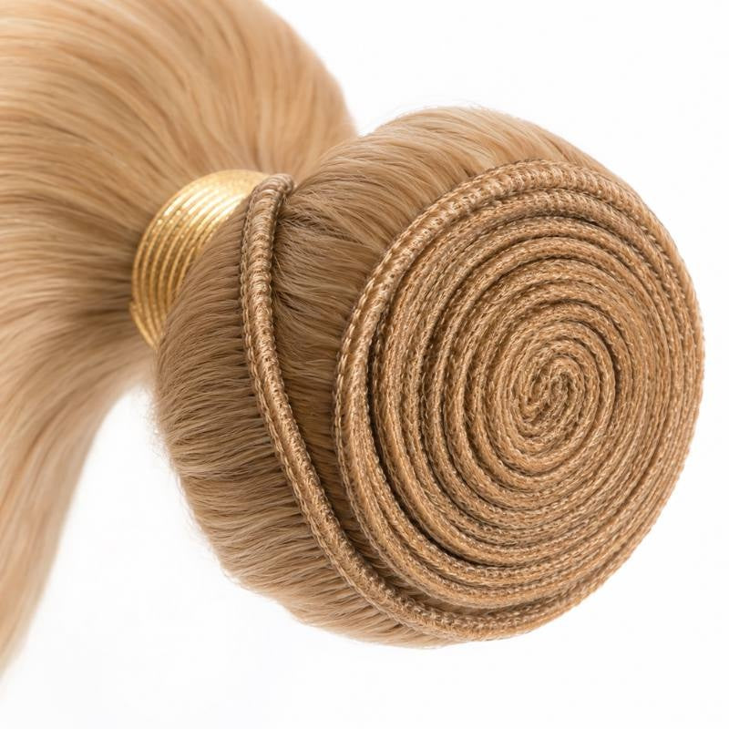 Close-up of the stitched weft coiled into a spiral on a single bundle of honey blonde 27 body wave sew-in hair extensions