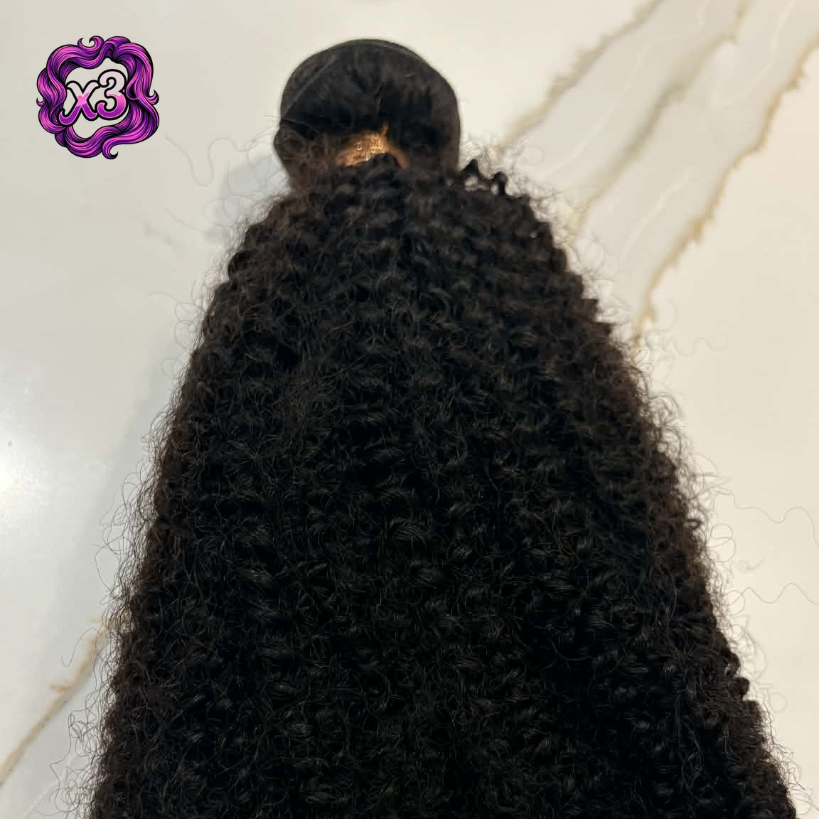 3 bundle deal — 16 inch Brazilian afro kinky curly sew-in hair extensions bundle on marble surface showing dense tight coils and weft construction