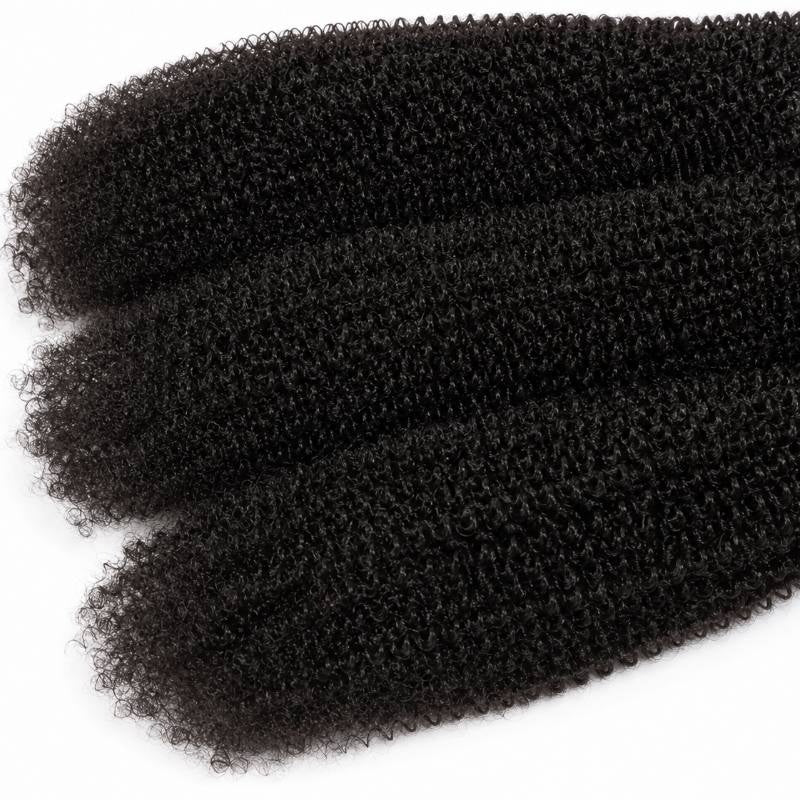 Crop of the tapered tips on three bundles of natural black 1B afro kinky curly sew-in hair extensions fanned across white