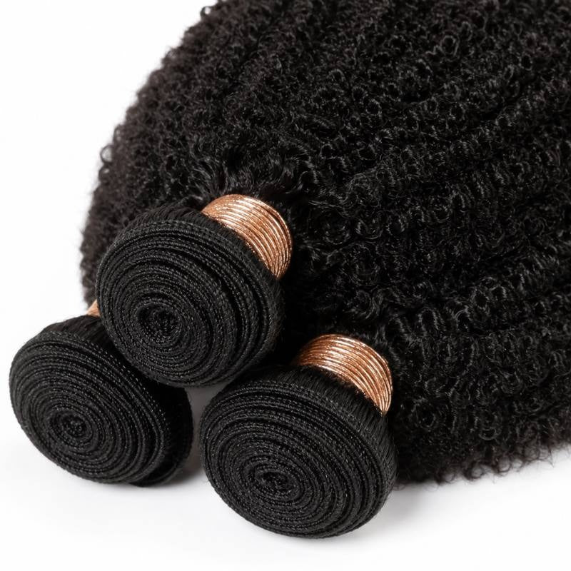 Close-up of the coiled wefts and copper bands on three bundles of natural black 1B afro kinky curly sew-in hair extensions