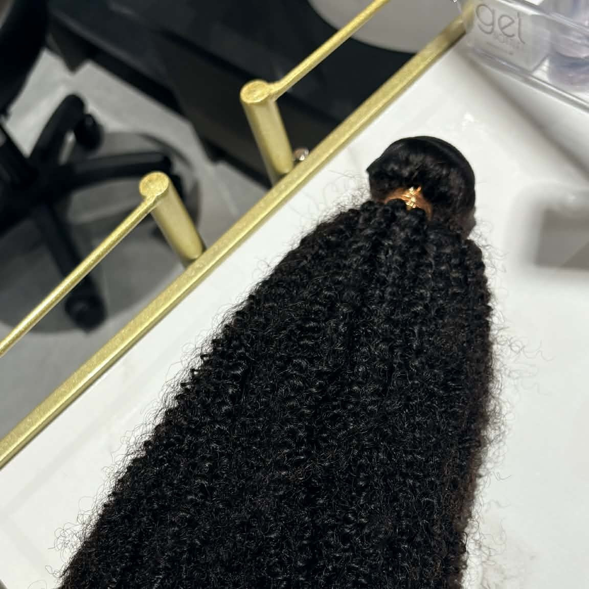16 inch Brazilian afro kinky curly sew-in hair extensions bundle on gold tray showing weft construction and tight coil definition