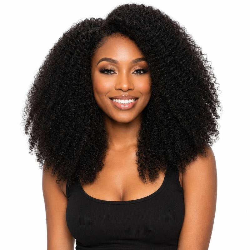Model smiling and facing forward wearing natural black 1B afro kinky curly sew-in hair extensions with a middle part on white