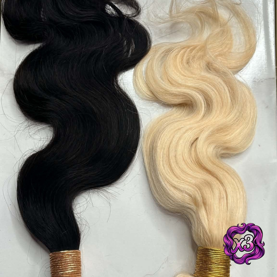 3 bundle deal — Two sew-in hair extensions bundles side by side in natural black and blonde body wave on marble showing S-wave texture comparison