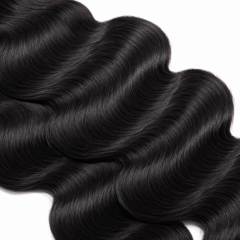 Close-up of the S shaped wave pattern along natural black body wave sew-in hair extensions laid on a white background