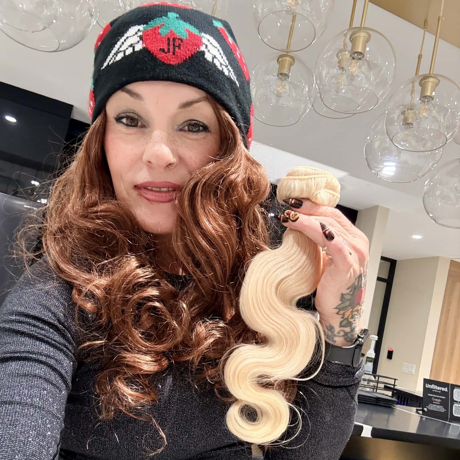 Close-up of 16 inch blonde 613 body wave sew-in hair extensions bundle showing platinum wave texture and weft construction