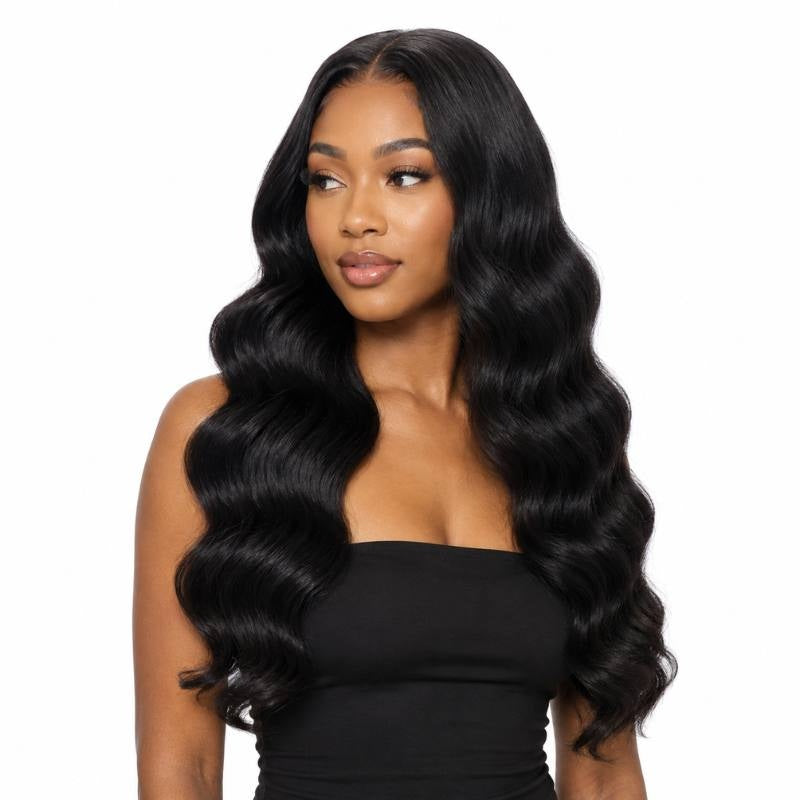 Model in a black top looking to one side wearing long natural black body wave sew-in hair extensions on a white background