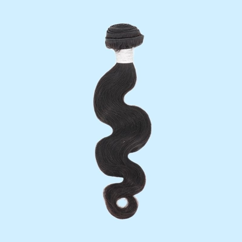 Single bundle of natural black body wave sew-in hair extensions on a pale blue backdrop with white thread wrapped below the weft