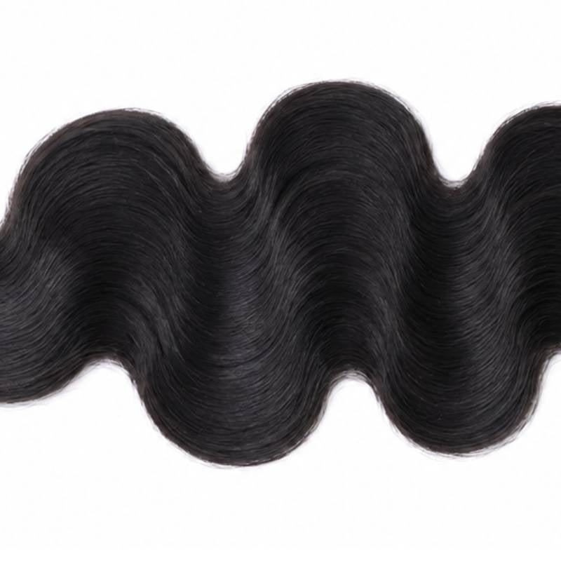 Close-up of the rolling wave crests on natural black body wave sew-in hair extensions running across a white background