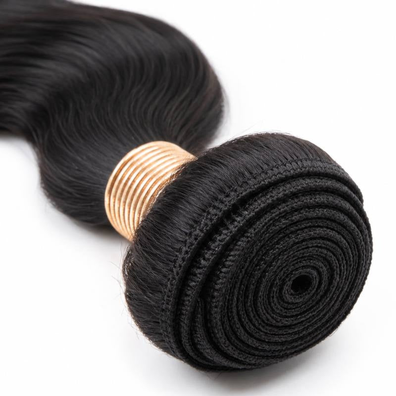 Macro view of the coiled weft on natural black body wave sew-in hair extensions showing the stitched track and tan thread wrap