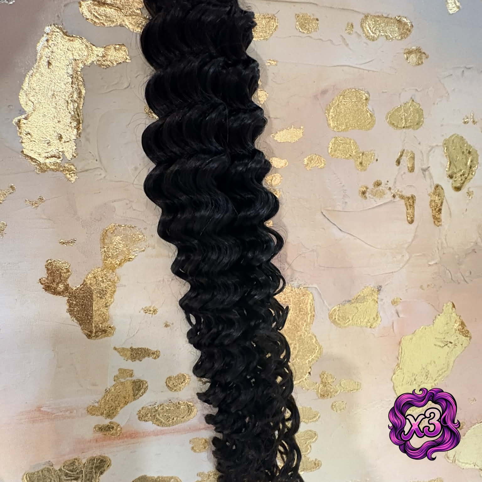 3 bundle deal — 16 inch Brazilian deep wave sew-in hair extensions bundle on pink and gold surface showing spiral curl definition and natural shine