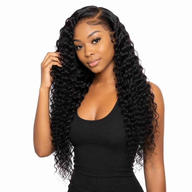 Model on white lifting one hand into long natural black deep wave sew-in hair extensions showing the crimped wave pattern