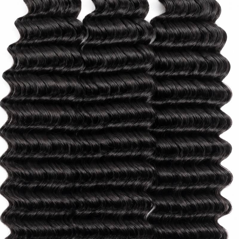 Close-up of the tight zigzag wave pattern across three bundles of natural black deep wave sew-in hair extensions