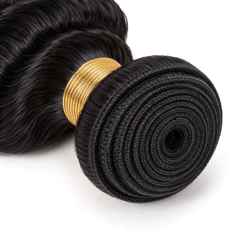Macro view of the coiled weft on natural black deep wave sew-in hair extensions showing the stitched track and gold thread wrap