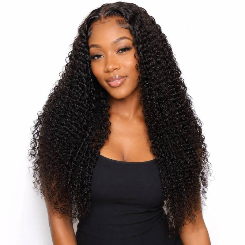 Model facing forward wearing long natural black kinky curly sew-in hair extensions with a deep side part on a white background