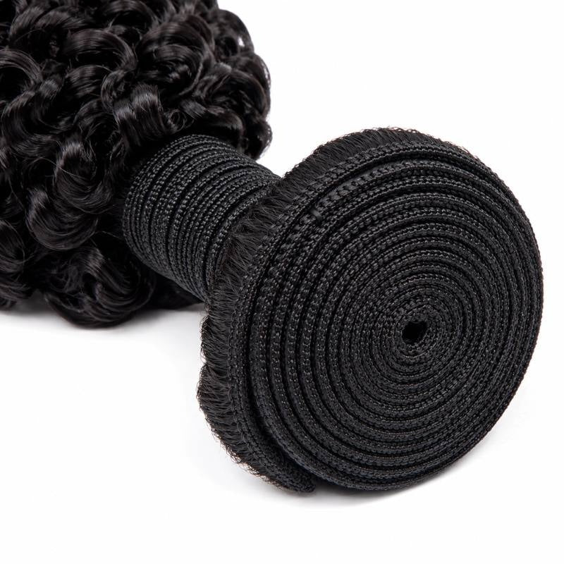 Macro view of the spiral coiled weft on natural black kinky curly sew-in hair extensions showing the stitched track and the root line