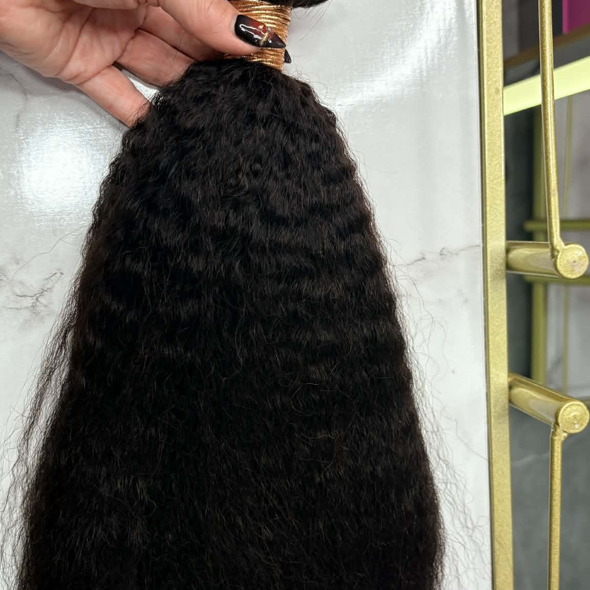 16 inch Brazilian kinky straight sew-in hair extensions bundle in gold frame showing blow-out texture from weft to tips