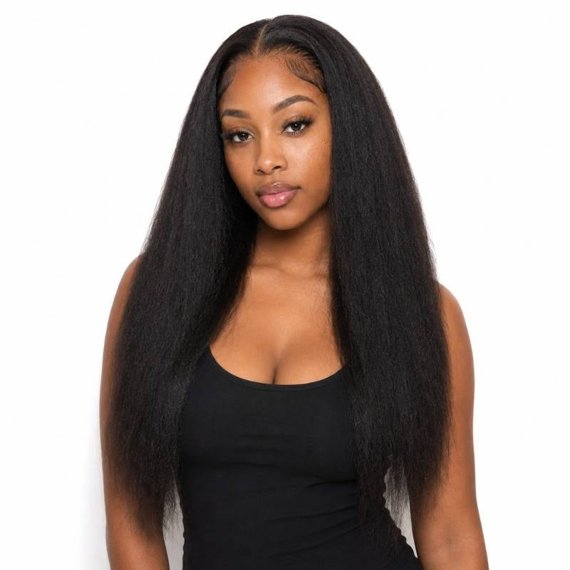 Model facing forward wearing long natural black kinky straight sew-in hair extensions with a side part on a white background